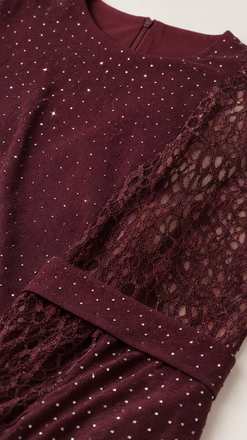 Close up of burgundy lace fabric with delicate sparkle rhinestone embellishment