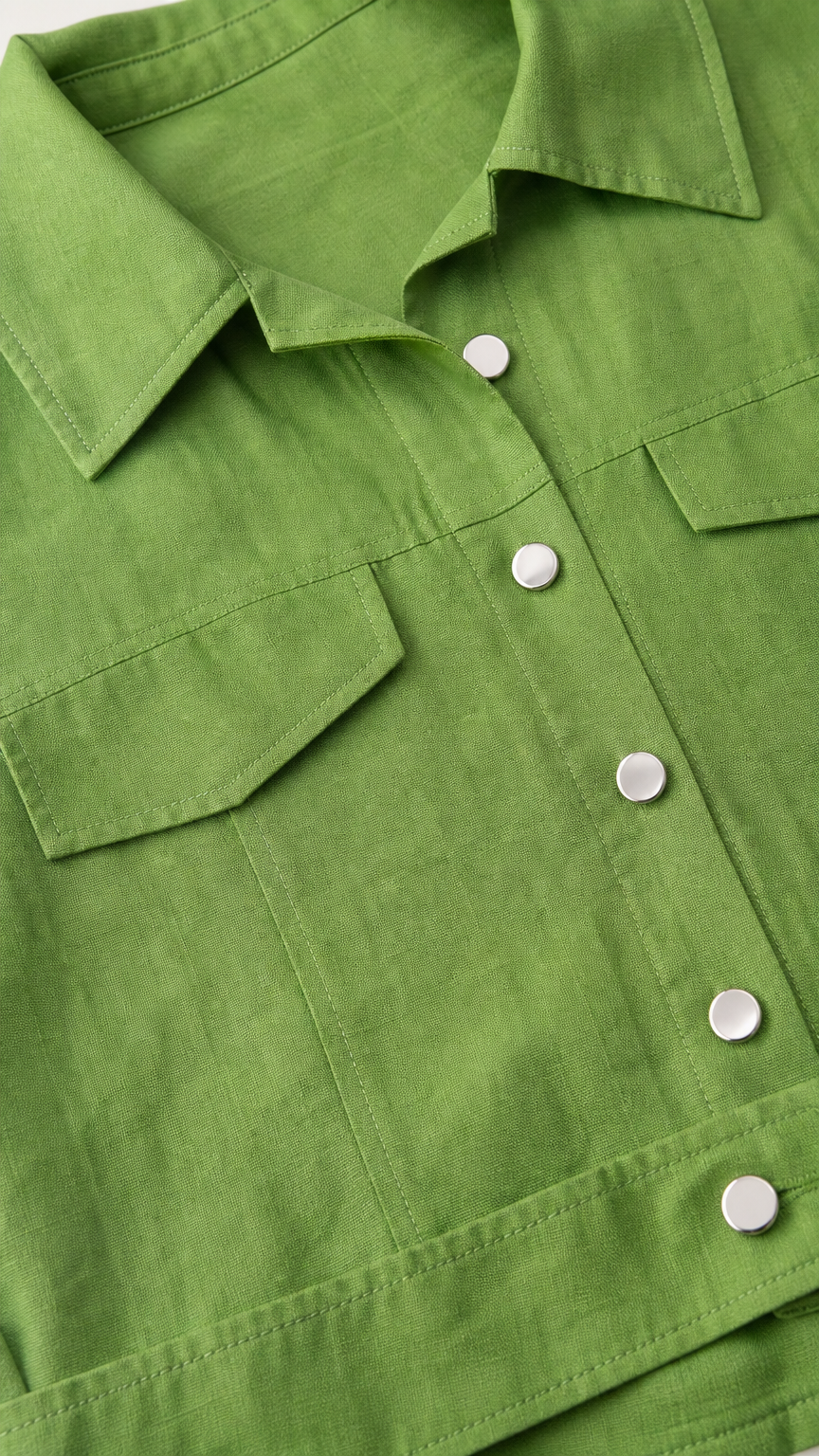 Close-up detail of the green shirt collar and button details
