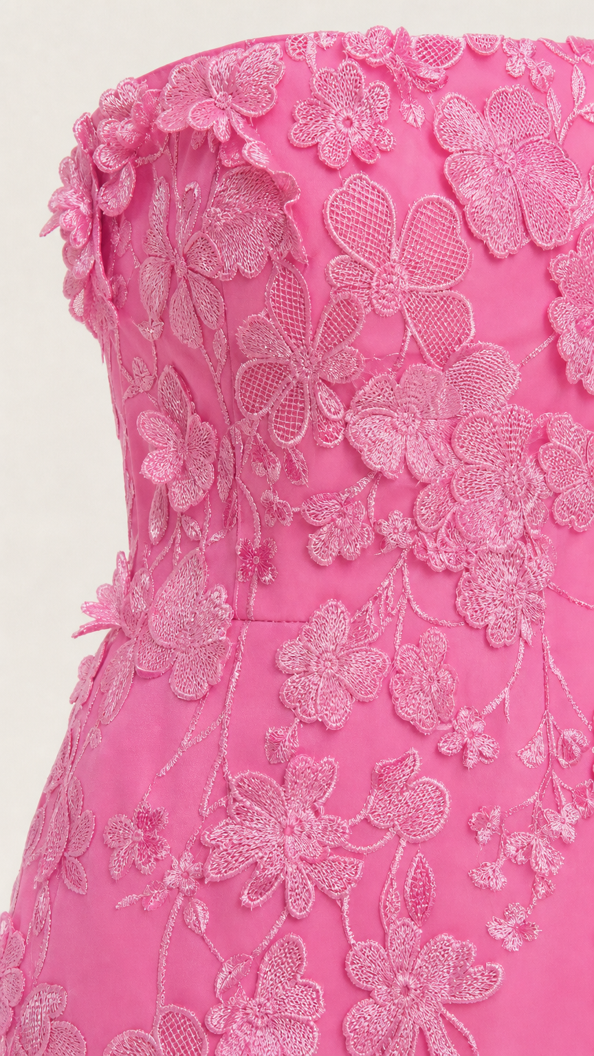 Close-up detail of textured floral appliques on pink bodice