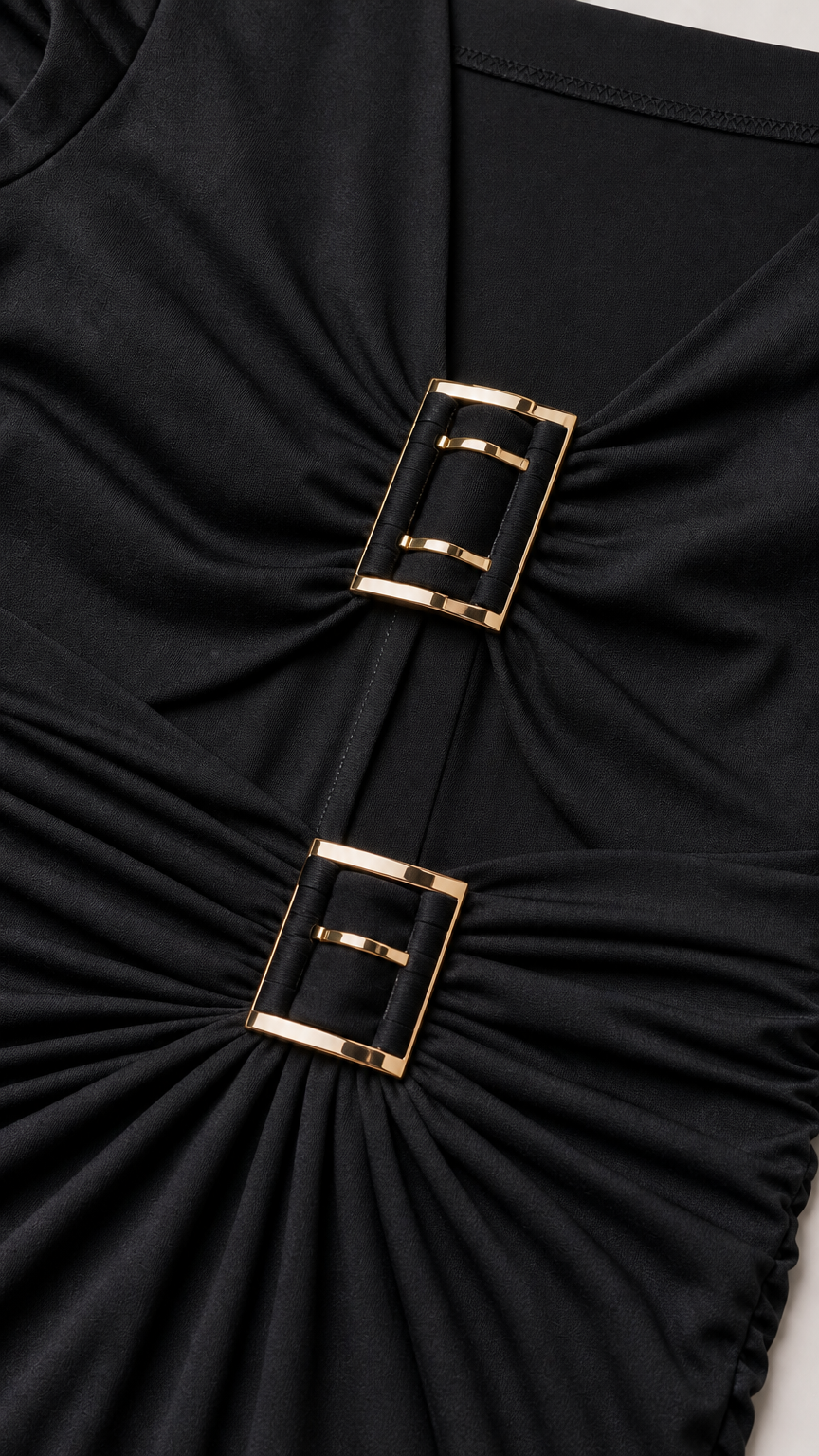 Close-up of metallic buckle accents on black dress bodice
