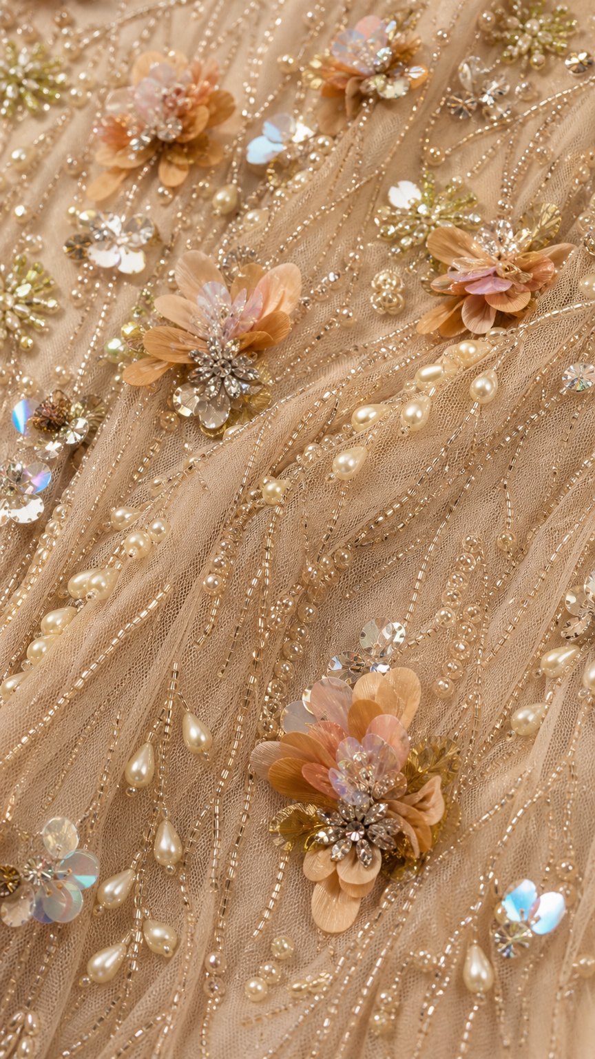 Close-up detail of 3D floral appliques, beads, and sequins on Champagne mesh fabric