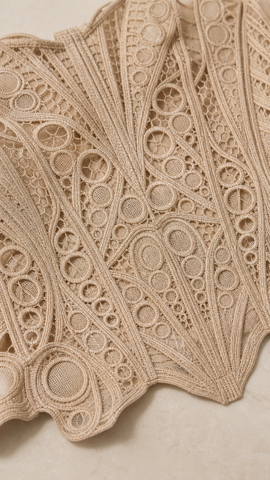 Close up fabric texture view of geometric crochet lace pattern in beige