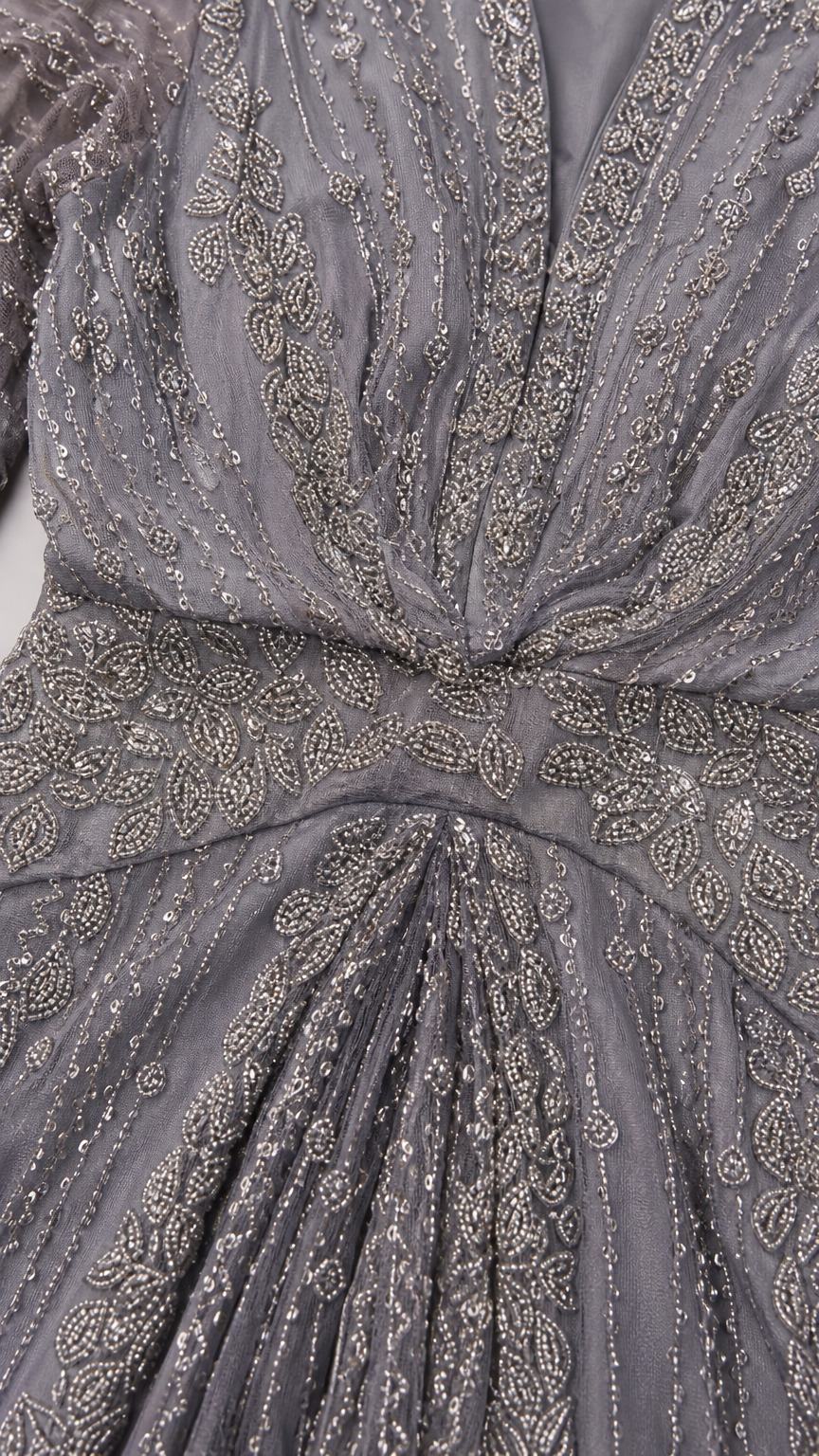 Close-up detail of intricate beading and sequin embroidery on slate grey bodice