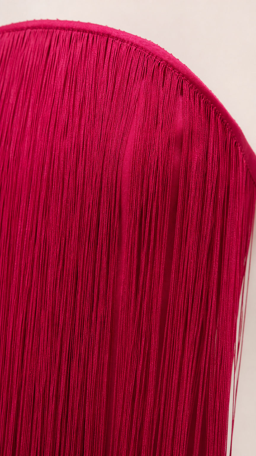 Close-up detail of upper neckline and layered fringe tassel texture
