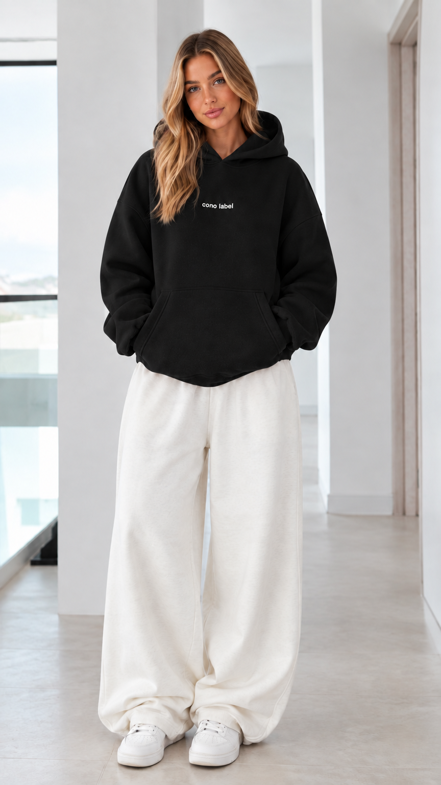 Women's oversized black pullover hoodie on model