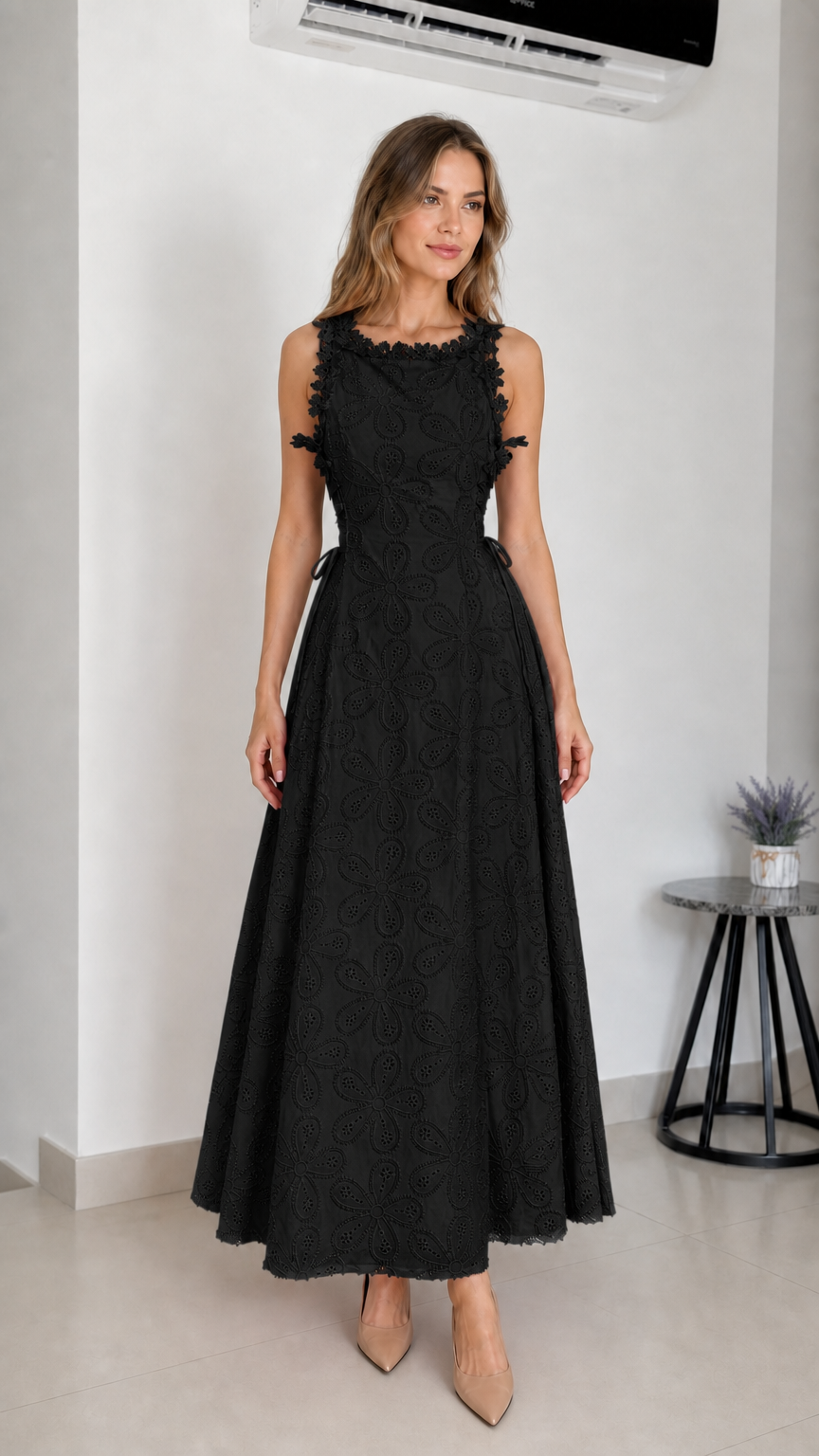 Model wearing black embroidered eyelet maxi dress