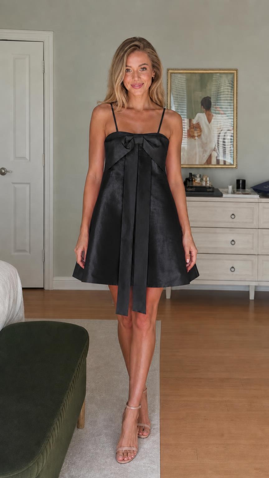 Model wearing black satin bow-front mini dress