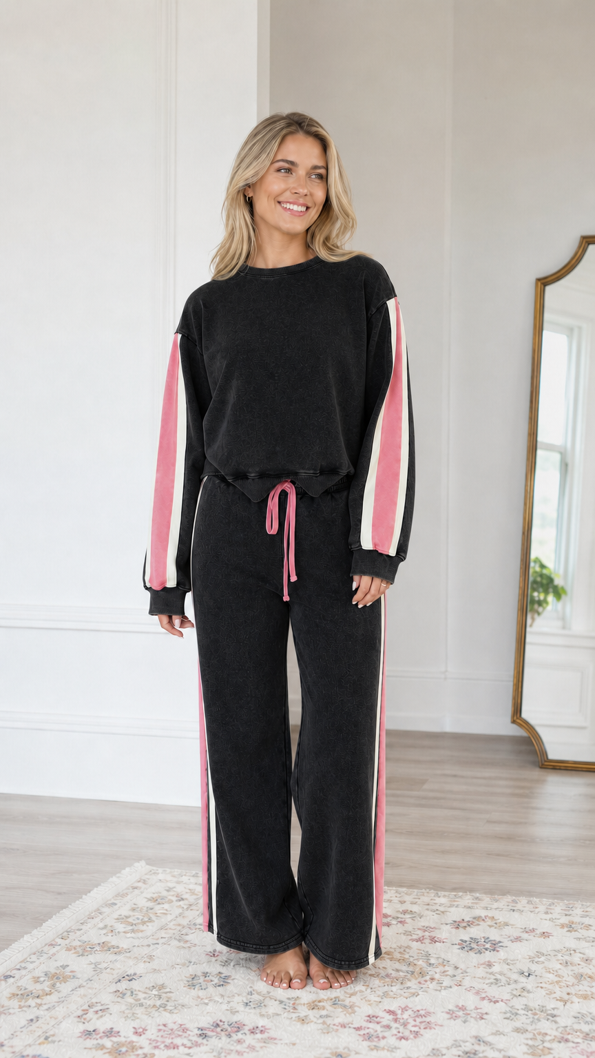 Front view of model wearing the Washed Black wide-leg sweatsuit set with pink and white side stripes
