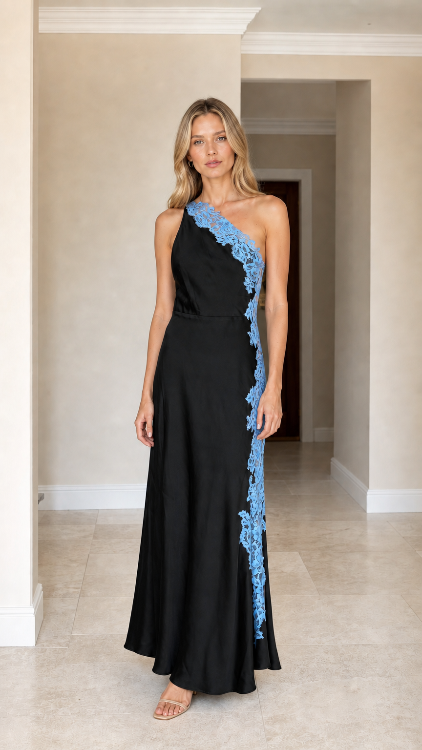 Front view of woman wearing black one-shoulder satin maxi dress with blue lace applique