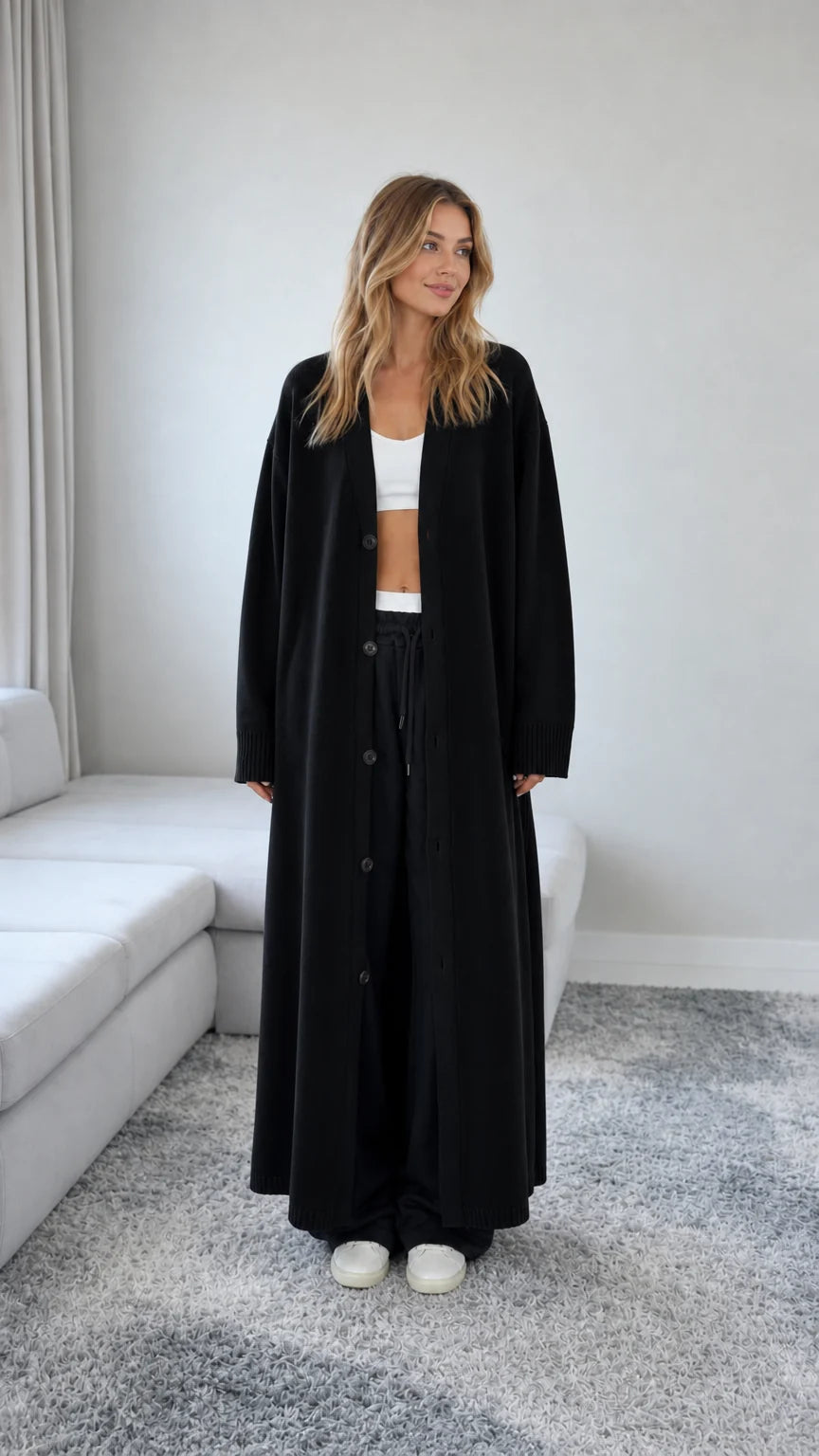 Front view of model wearing a Black floor length maxi duster cardigan
