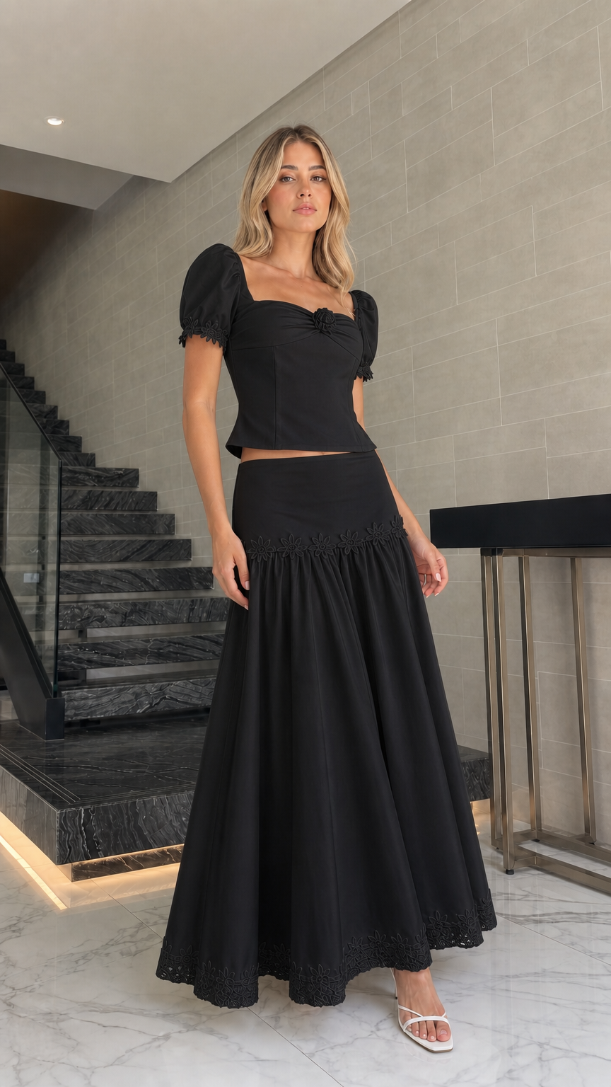 Model wearing black puff sleeve crop top and maxi skirt set