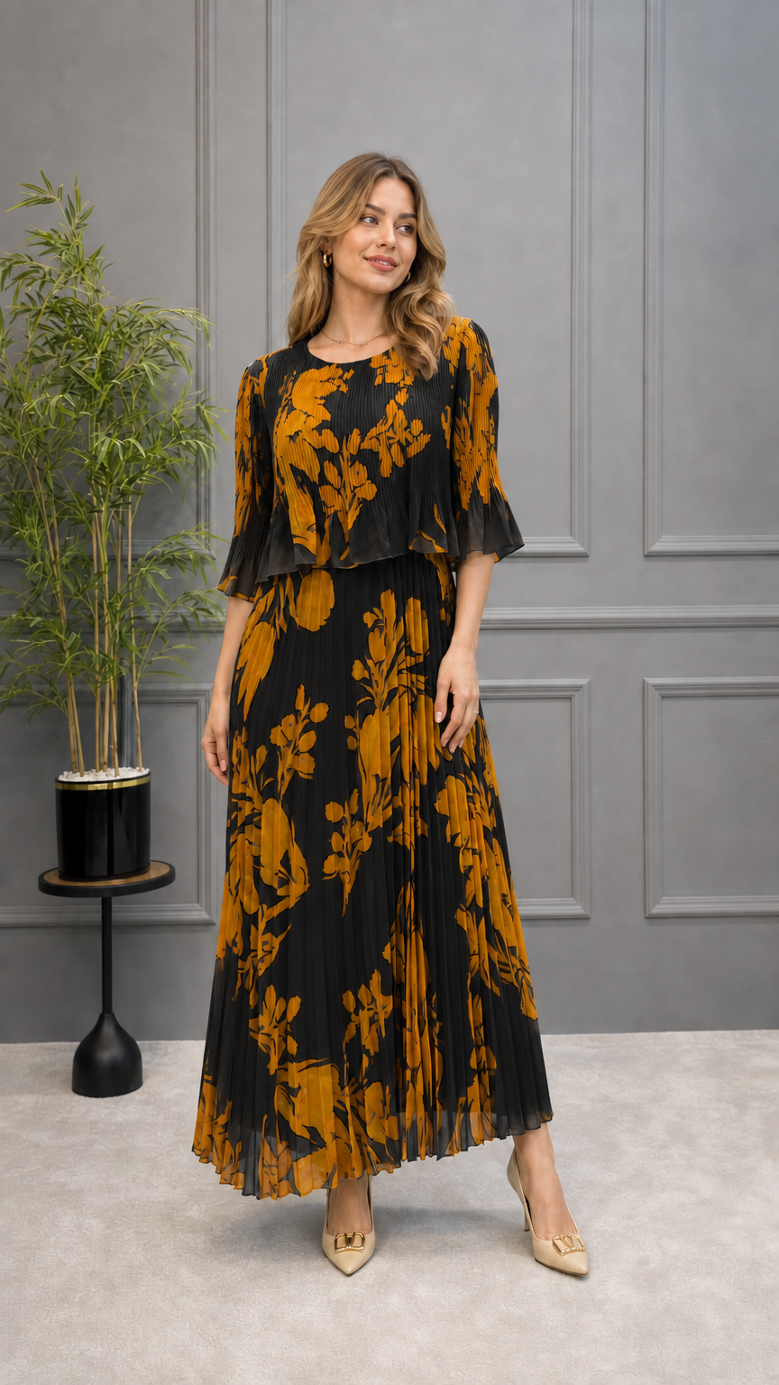 Model wearing black floral pleated maxi dress with tiered overlay top
