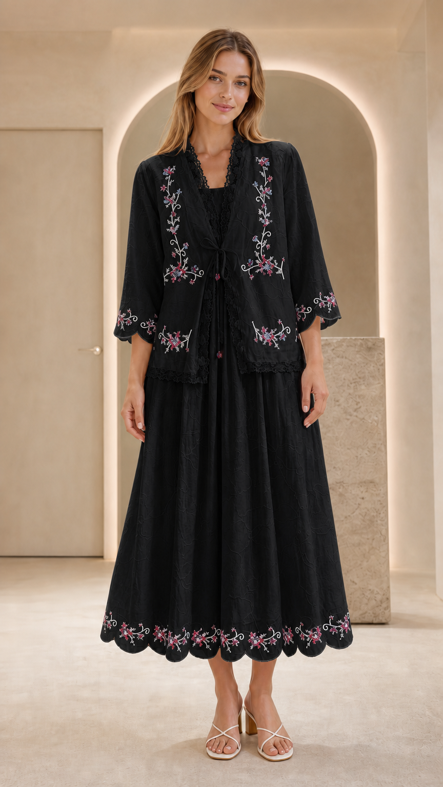 Front view of model wearing black embroidered two-piece dress set