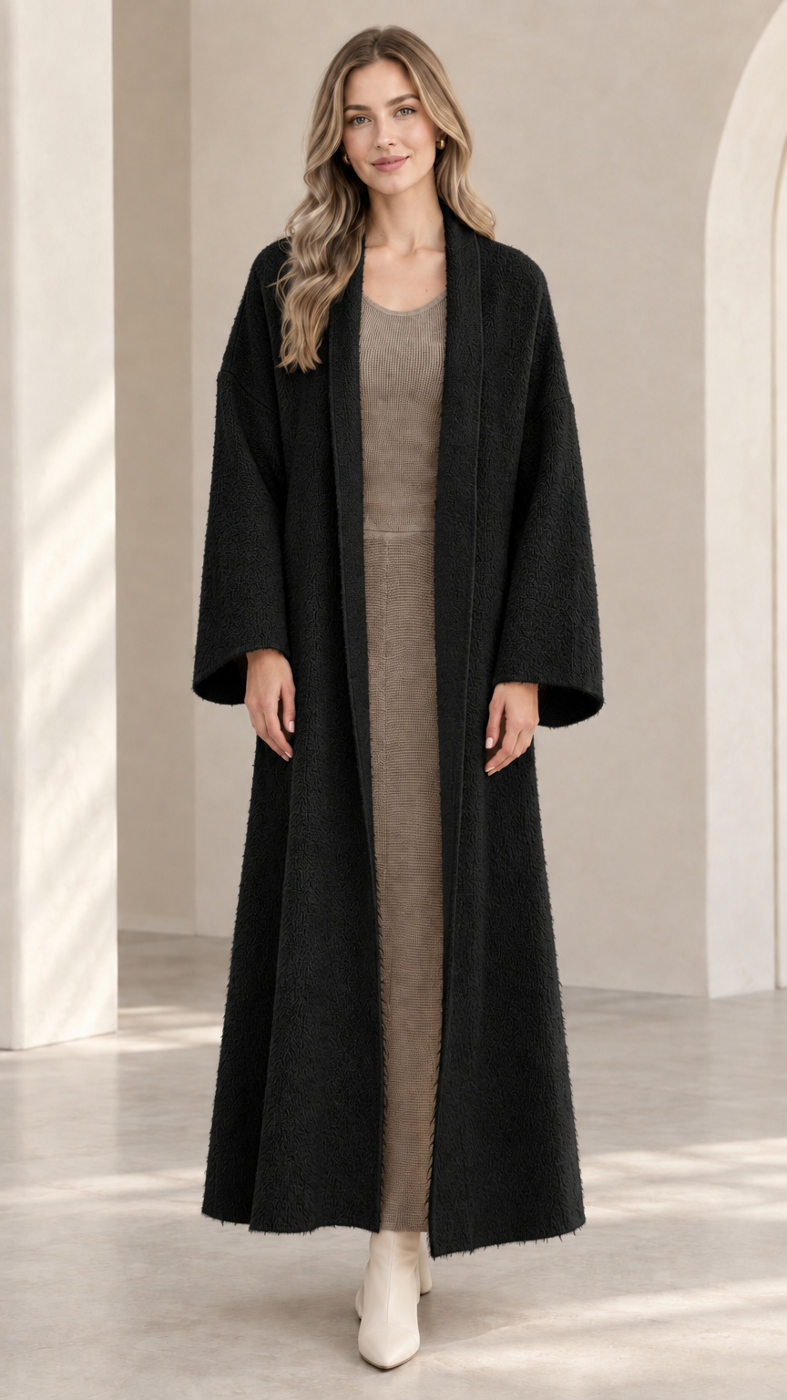 Front view of model wearing black textured maxi open-front duster coat