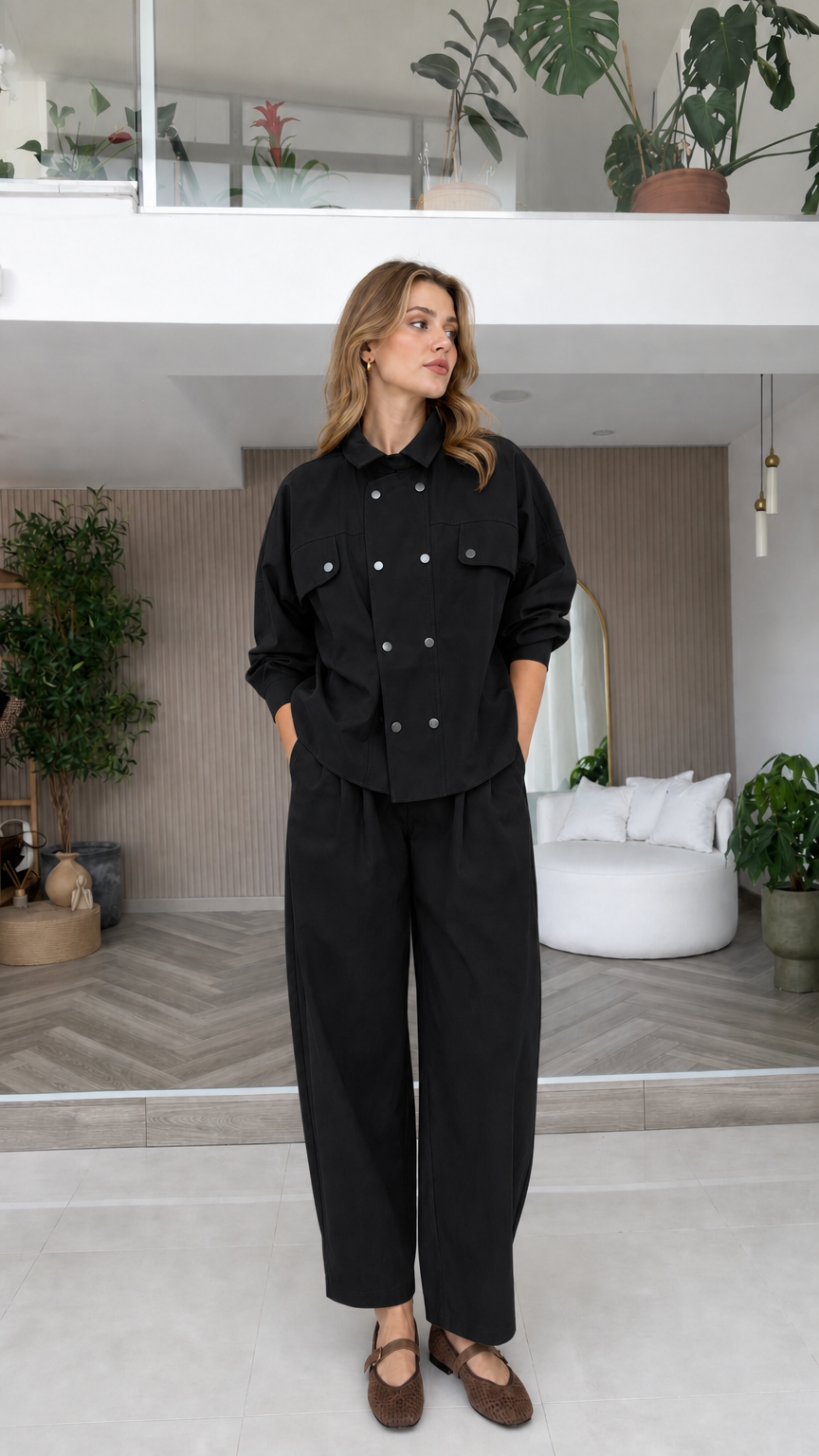 Model wearing black double-breasted shirt and wide-leg pants two-piece set
