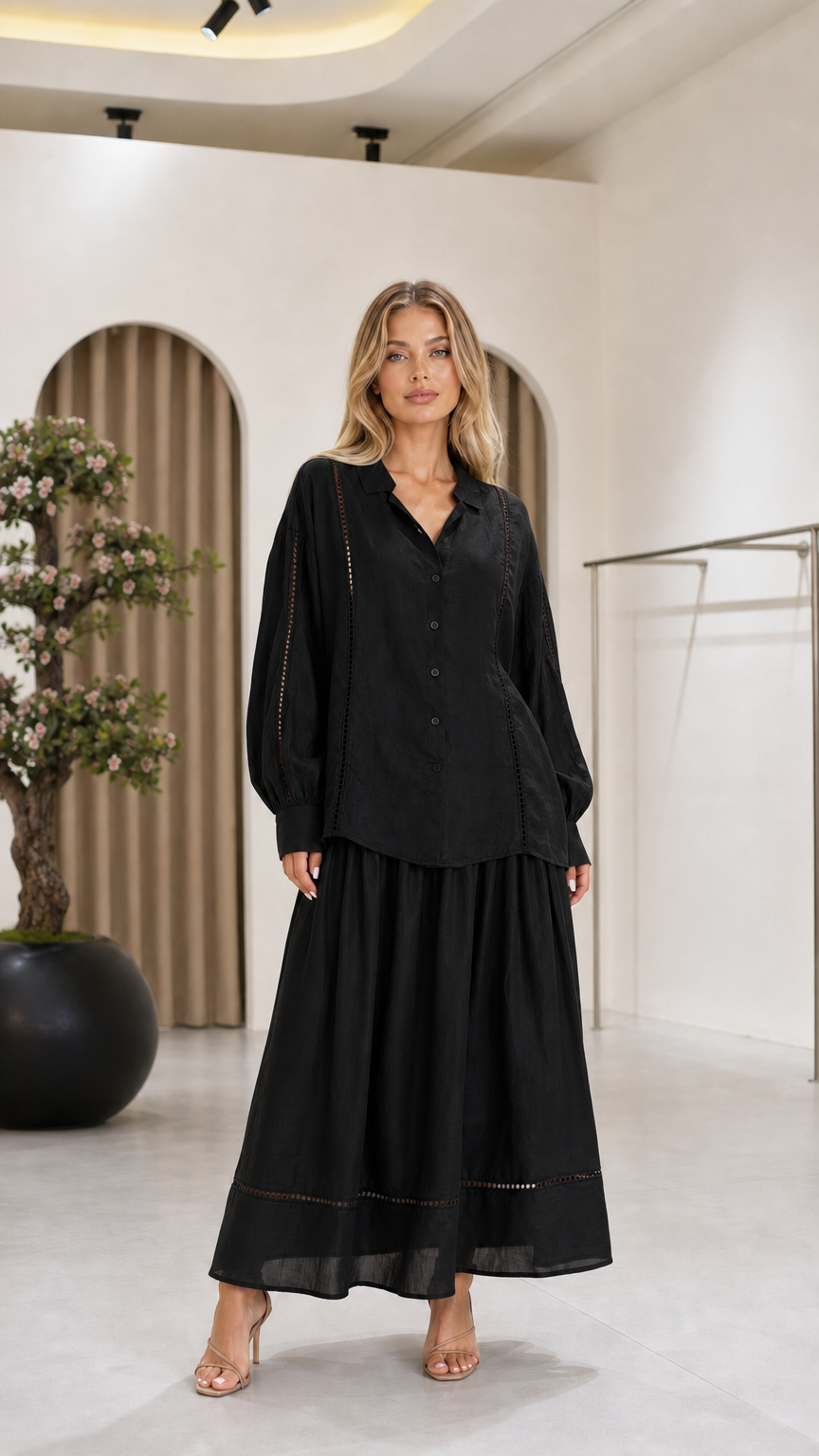 Front view of the black women's blouse and maxi skirt two-piece set