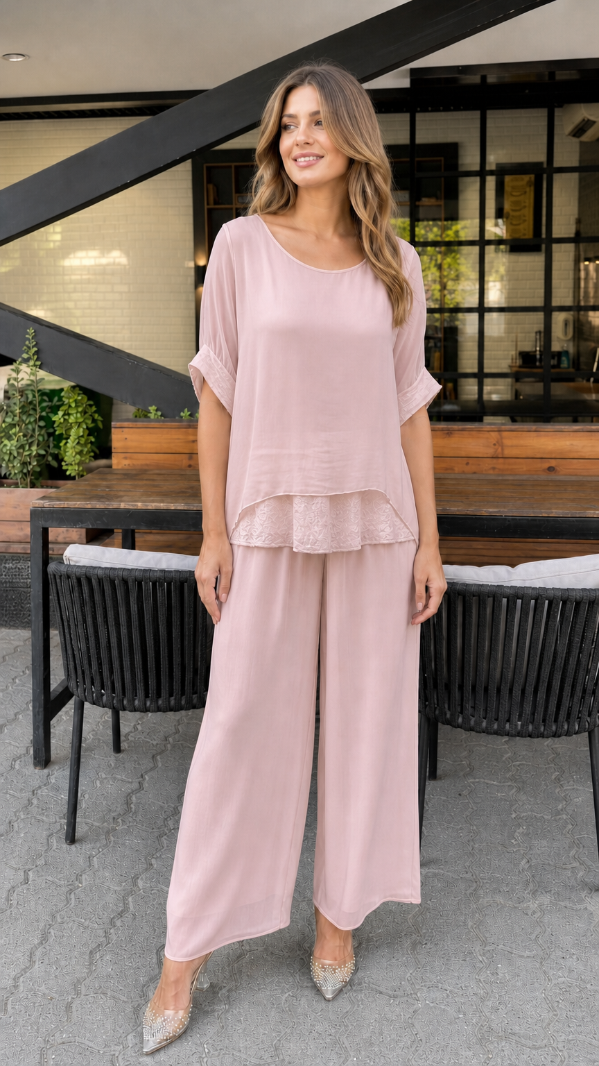 Model wearing pink layered tunic and wide-leg pants set