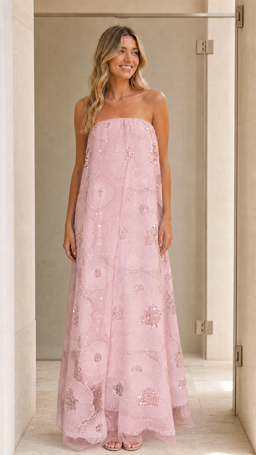Model wearing pink strapless sequin floral maxi dress