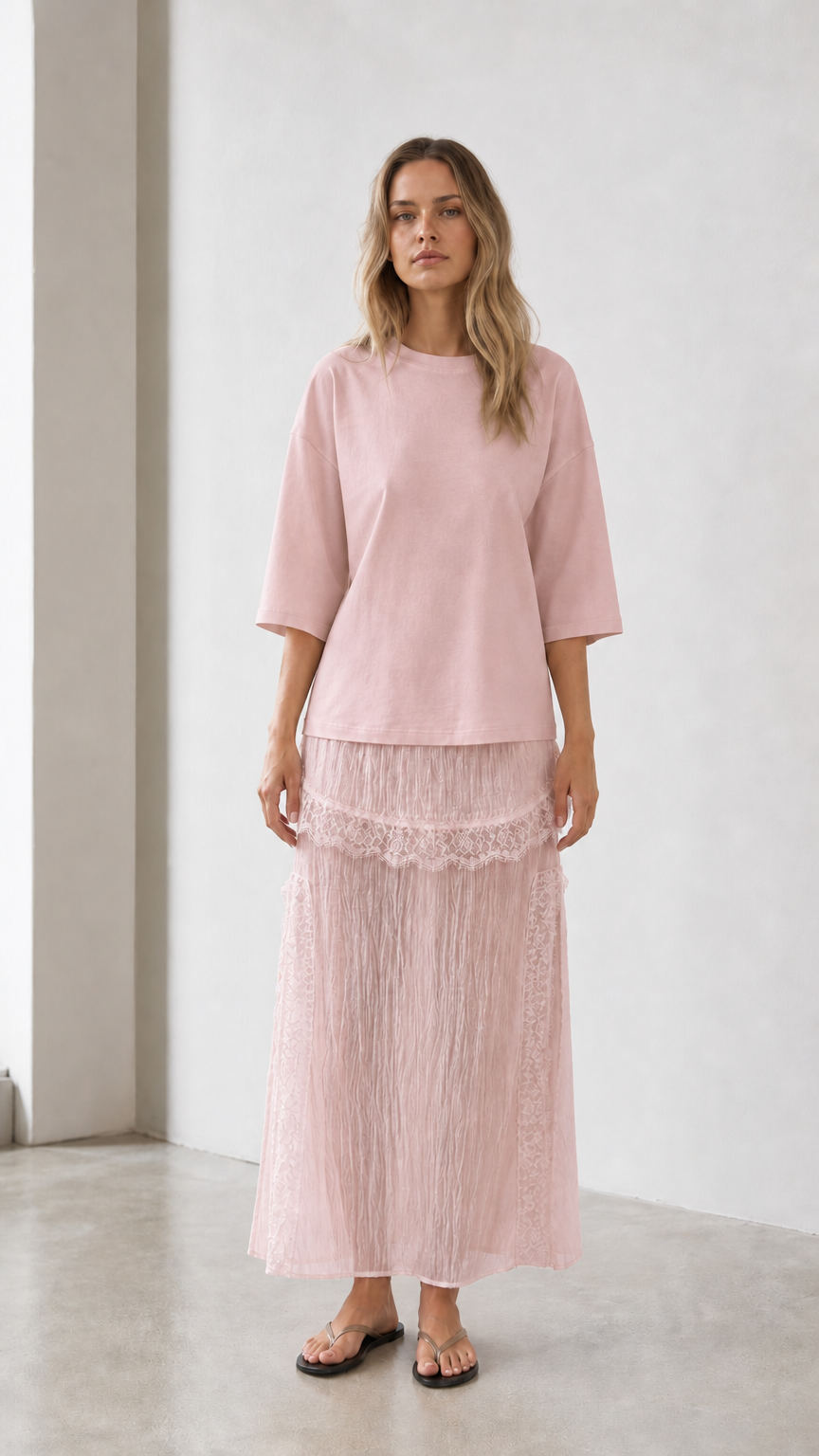 Front view of woman wearing pink relaxed tee and matching skirt set