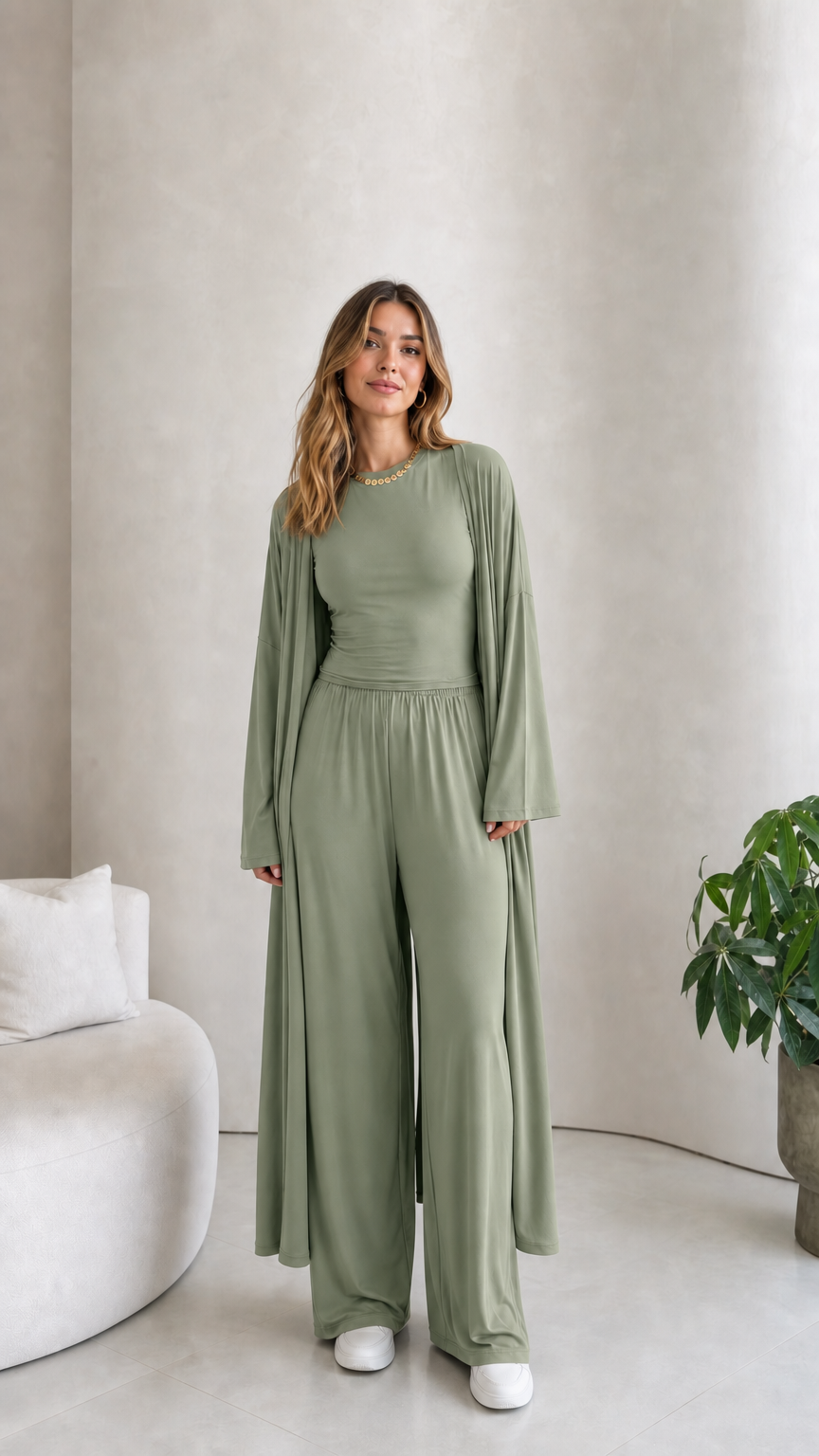 Front view of model wearing the 3-piece duster cardigan and pants set in sage green