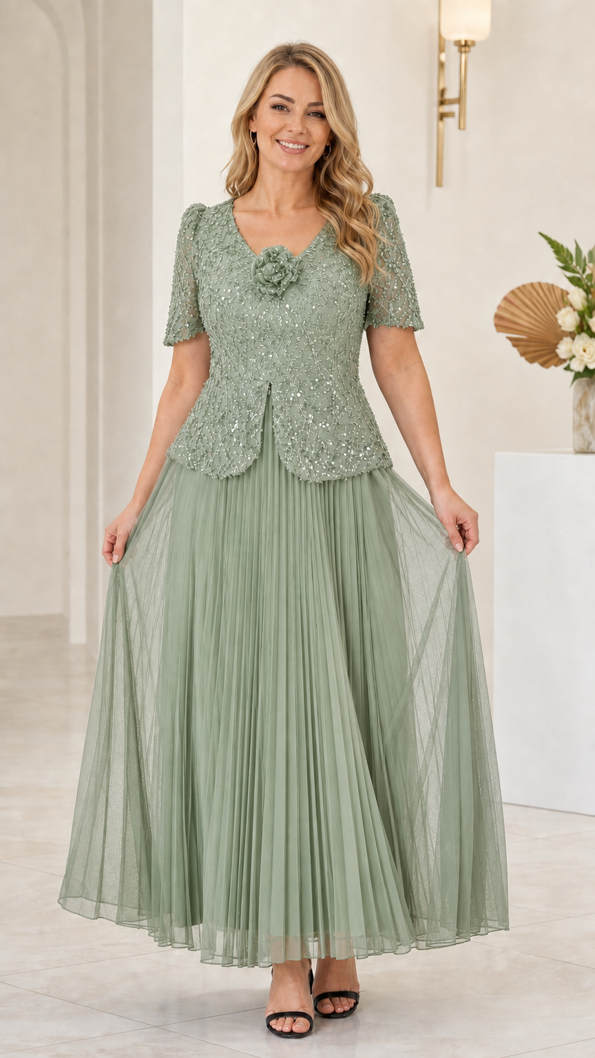 Front view of sage green sequin floral applique pleated evening gown