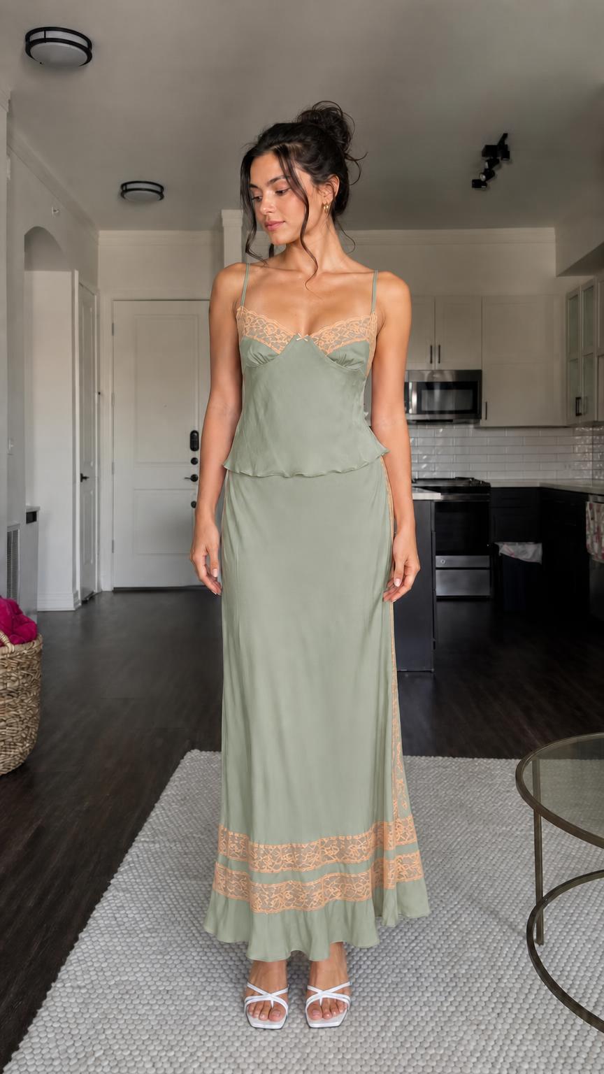 Model wearing sage green two-piece satin set