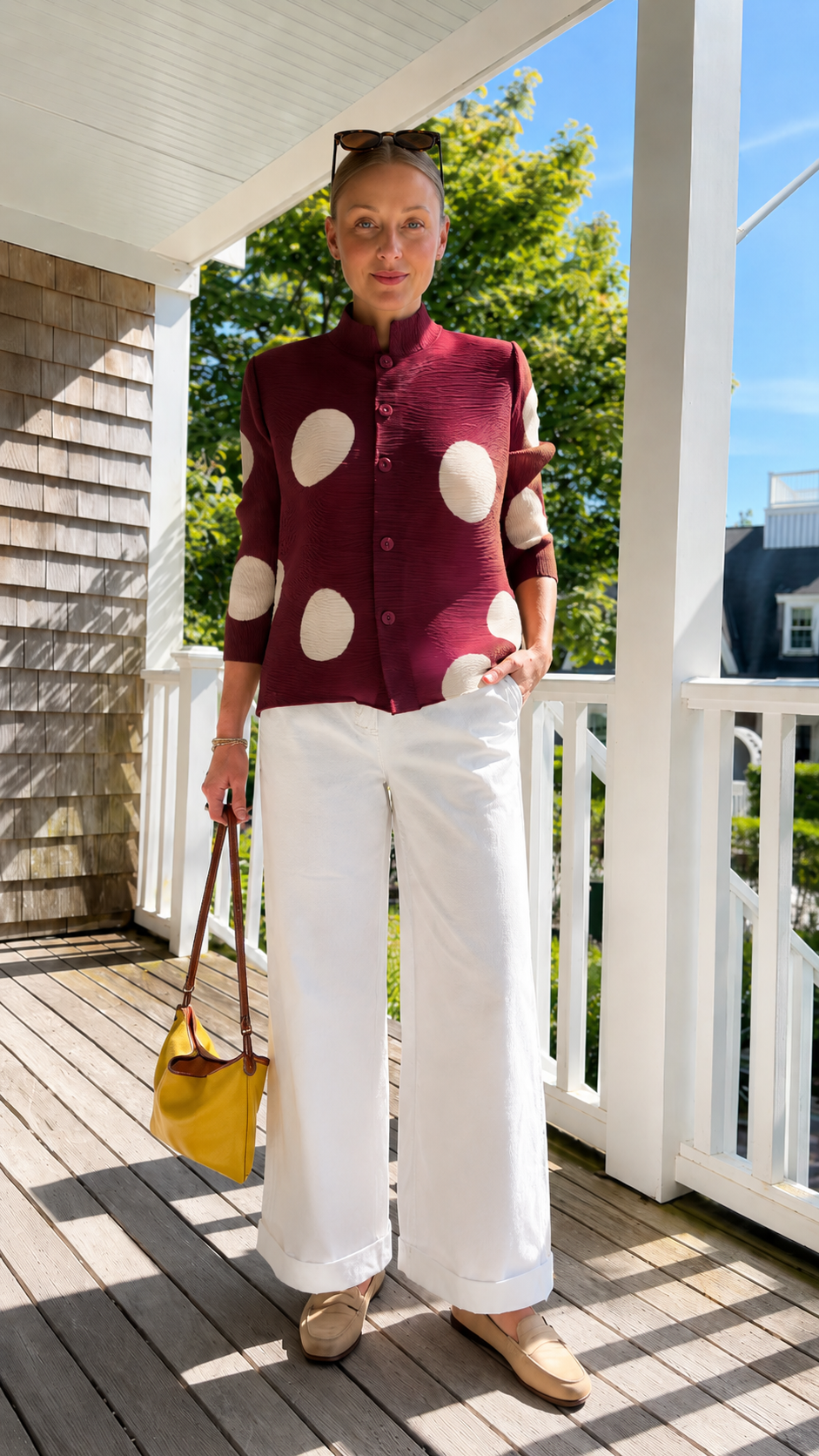 Front view of burgundy pleated polka dot button-front jacket top styled for smart casual wear