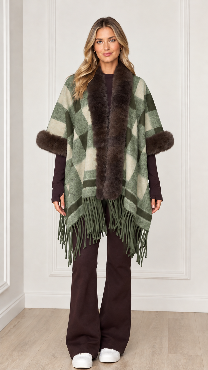 Woman wearing sage green plaid poncho wrap with faux fur collar and hem tassels