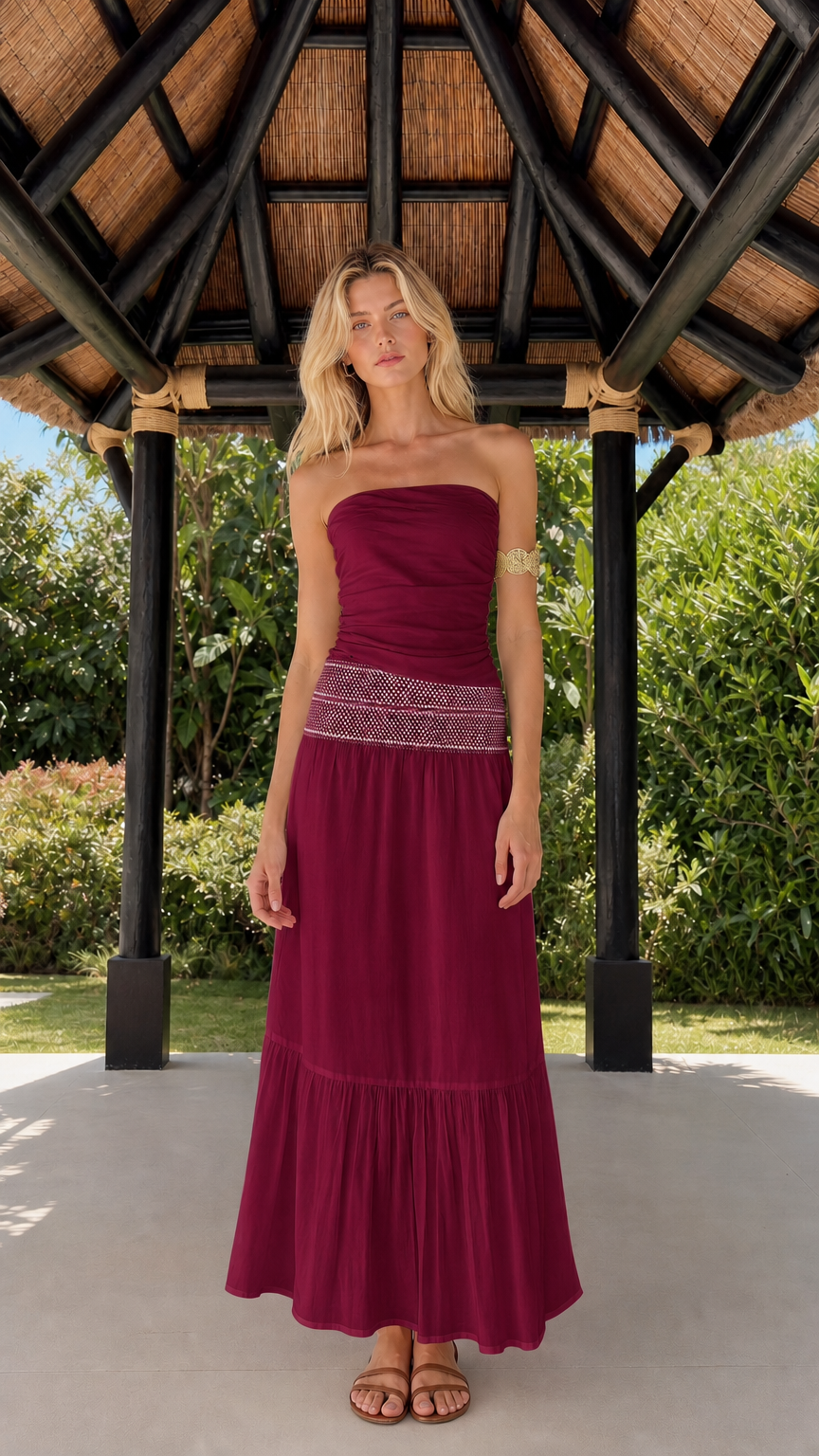 Woman wearing burgundy strapless tiered maxi dress
