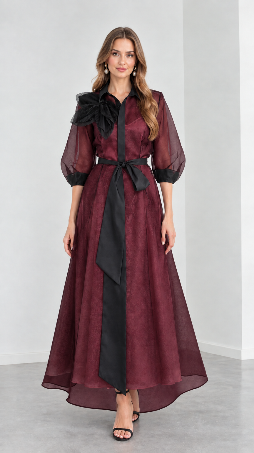Front view of model wearing rich Burgundy wine organza maxi gown with black ribbon belt