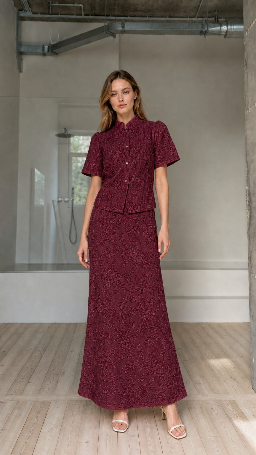 Model wearing burgundy floral embroidered short-sleeve top and maxi skirt matching set