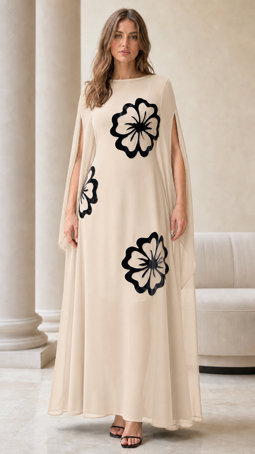 Champagne beige cape sleeve maxi dress with contrasting black floral motifs