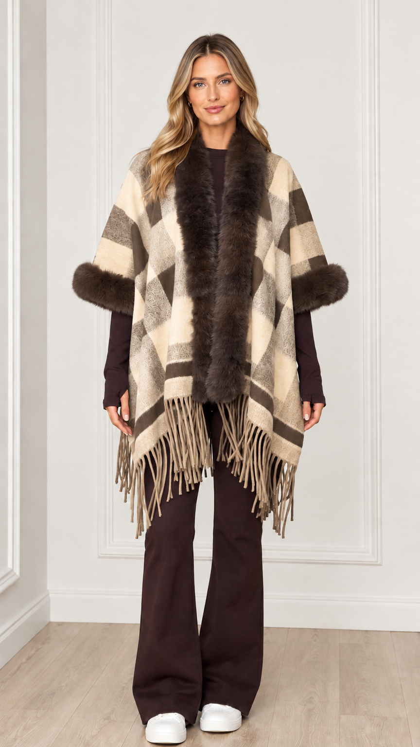 Woman wearing cream beige plaid poncho cape with faux fur accents