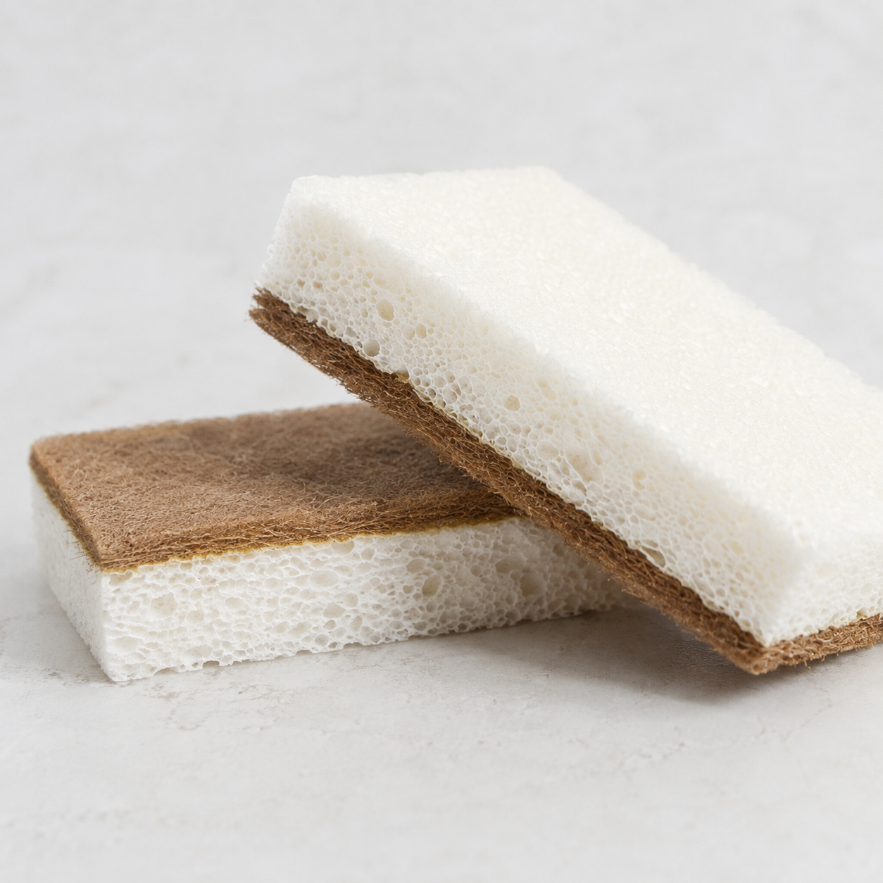 close-up of white cellulose sponge and brown walnut scrubber layer