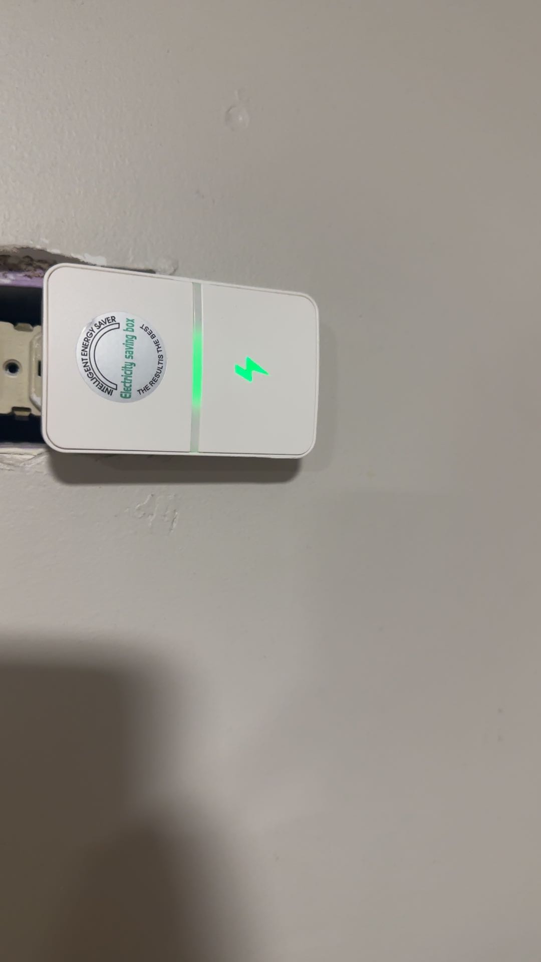 Energy saver plug mounted in a wall outlet