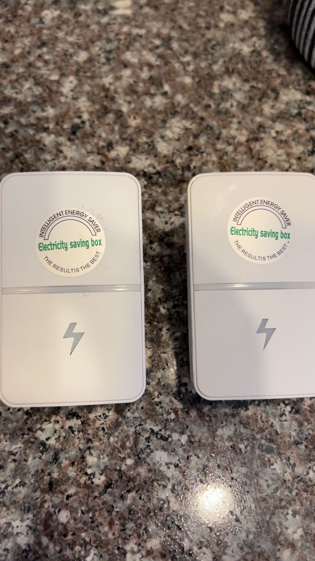 Hand holding the energy saver plug, size in hand