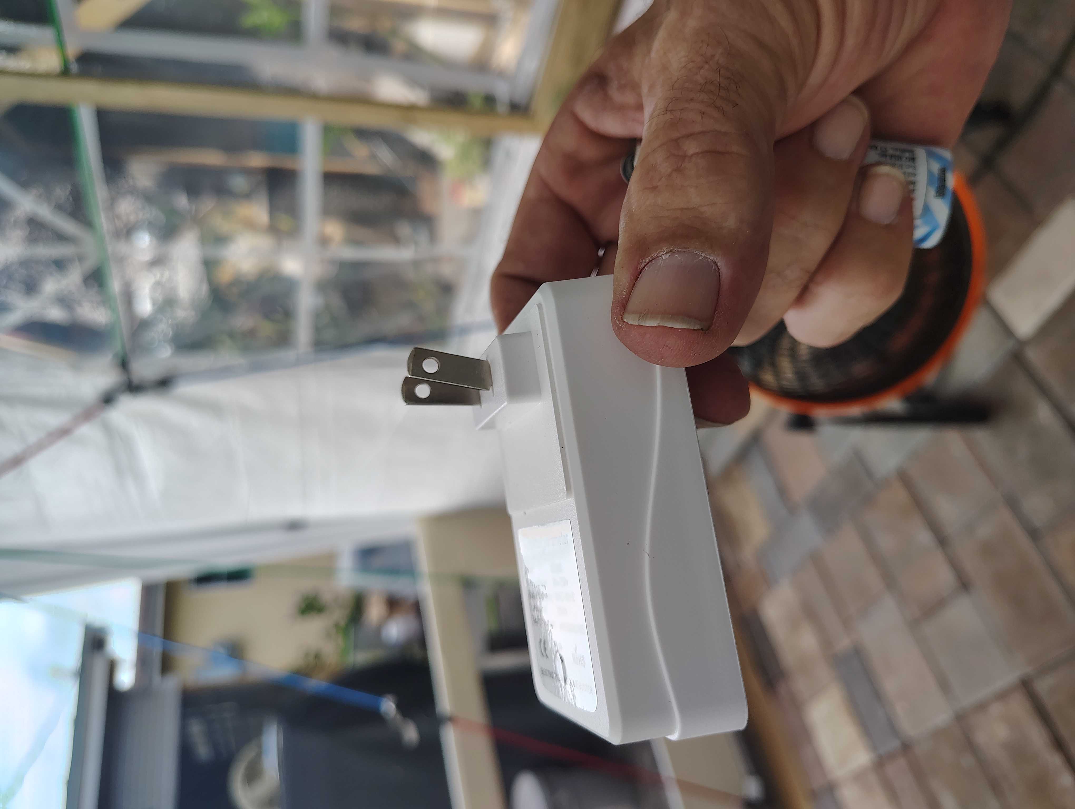 Two energy saver plugs held in one hand