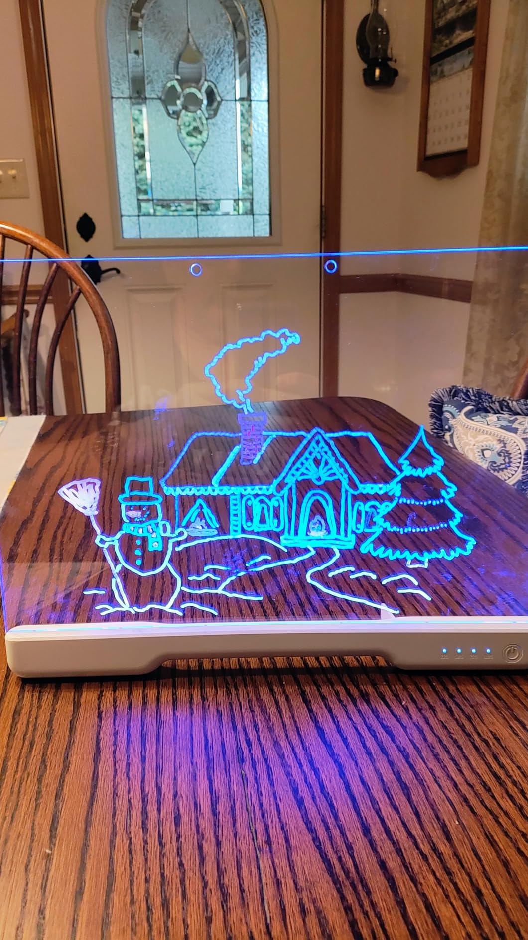 Glowing winter scene drawn on the LED drawing board at home