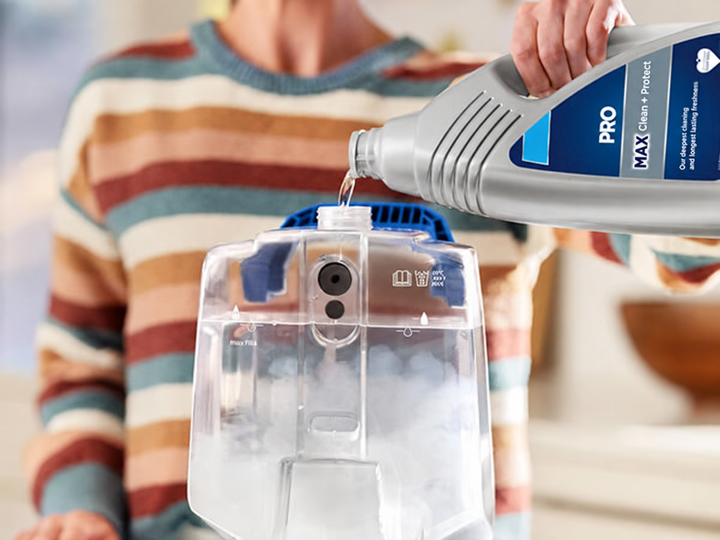 Pouring cleaning solution into the upright carpet cleaner tank