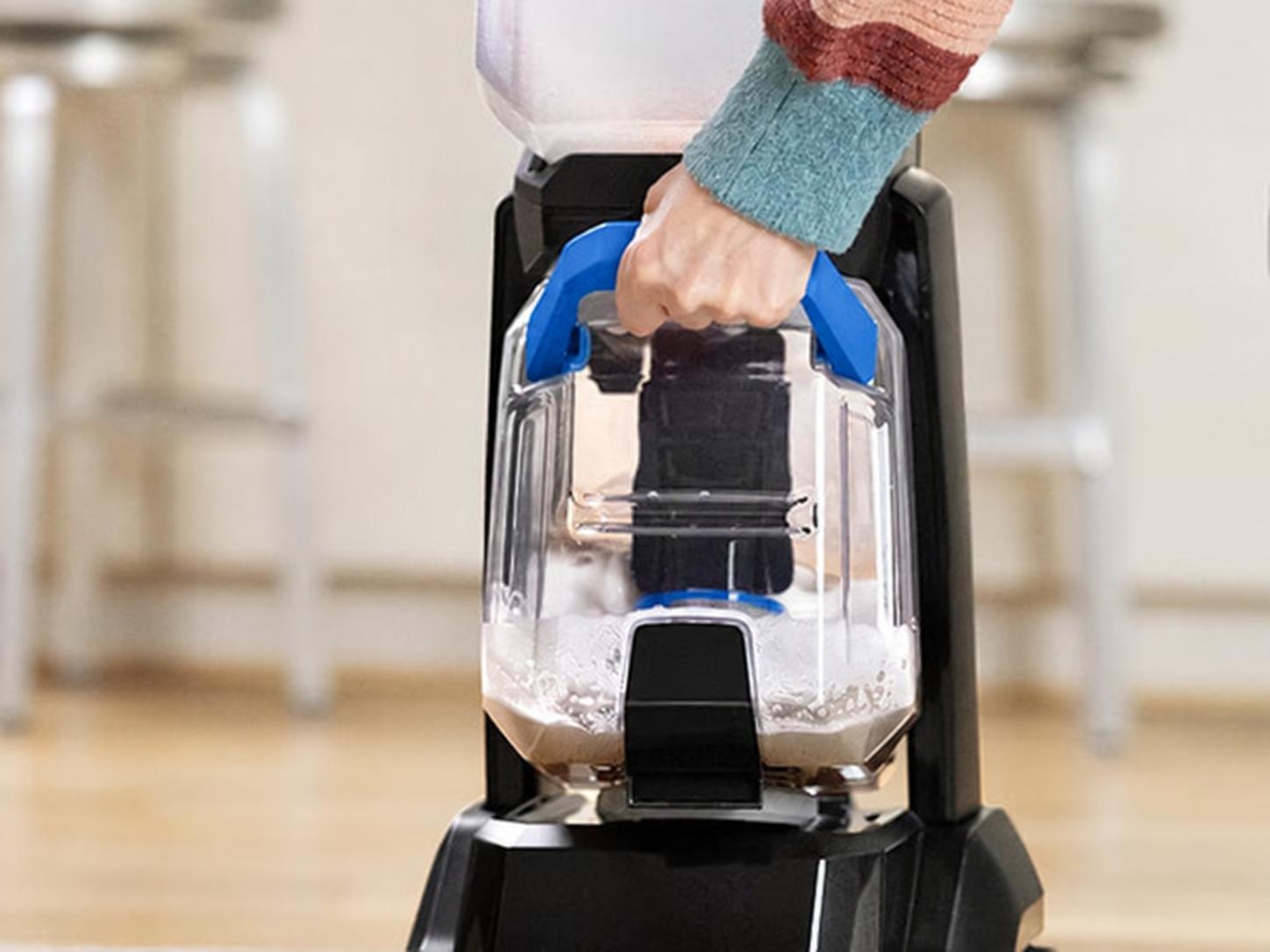 Removing the recovery tank from the upright carpet cleaner