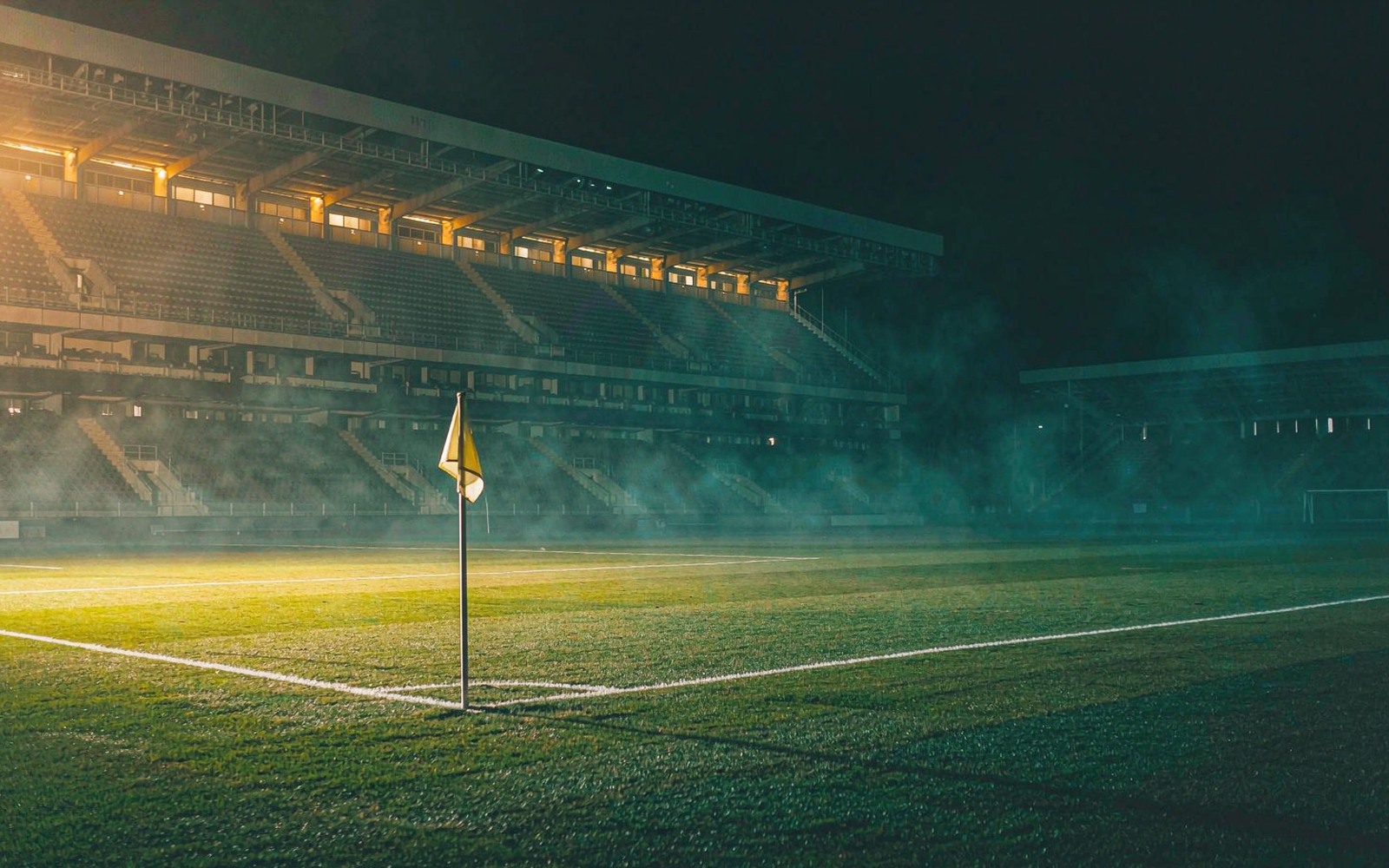 Corner flag on a floodlit pitch at night