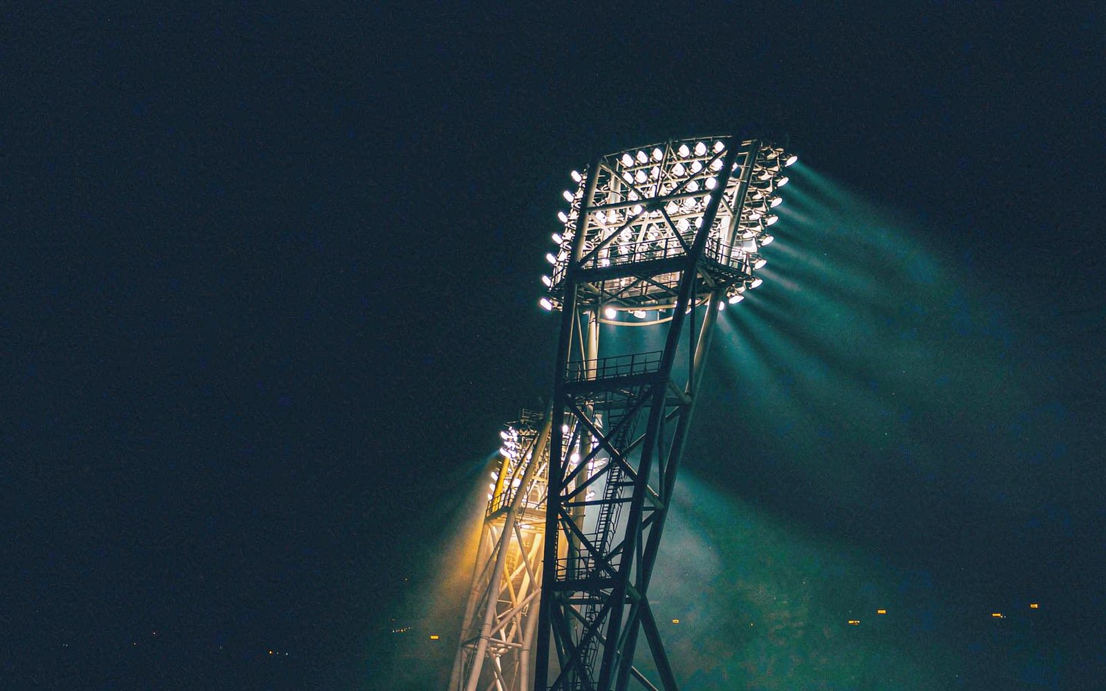 Stadium floodlight pylon against the night sky