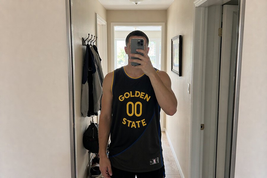 the black and gold basketball jersey in a hallway mirror selfie