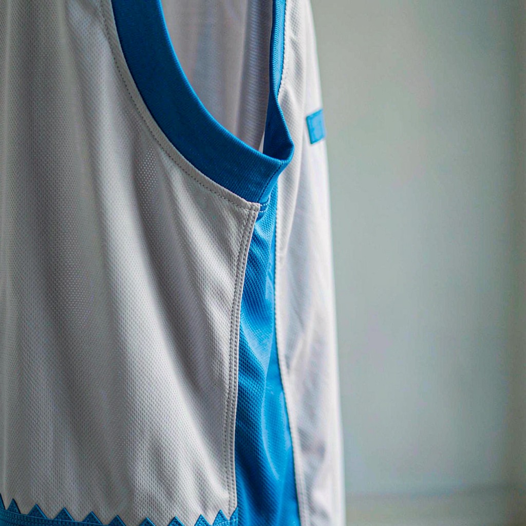 Basketball jersey mesh fabric and stitched trim detail