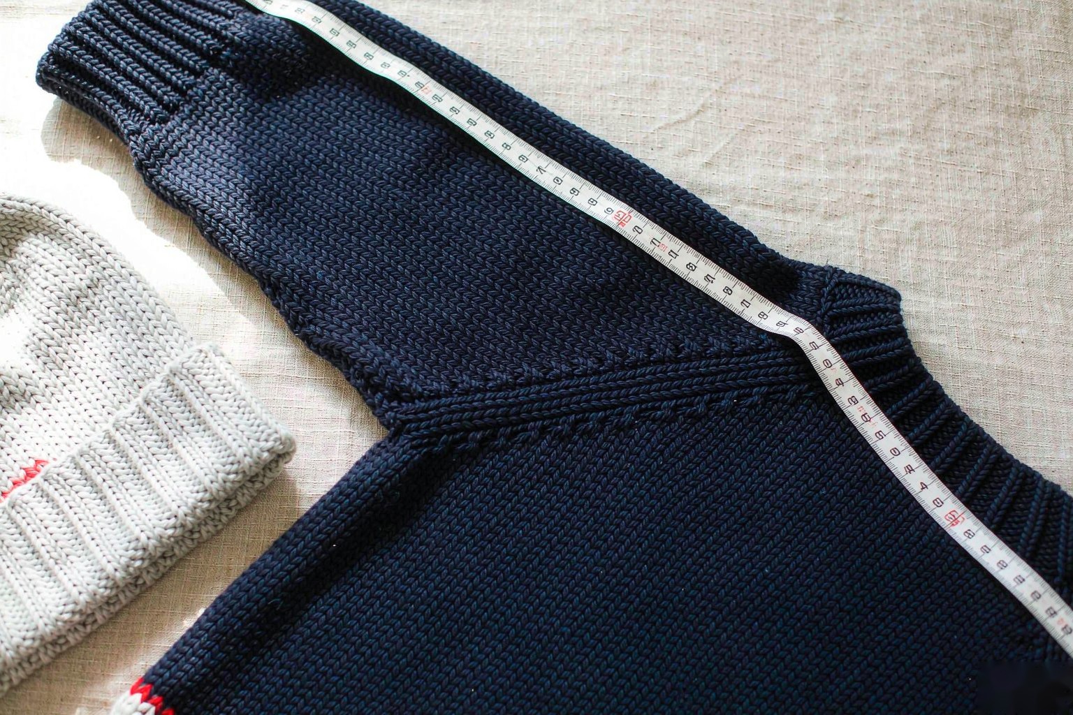 A measuring tape along the raglan sleeve of a hockey sweater