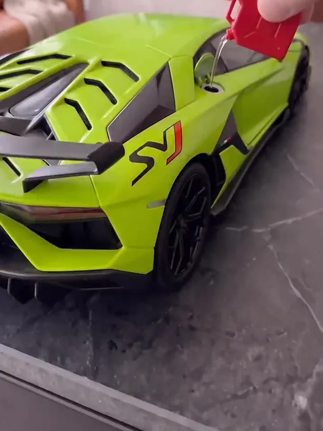 Close-up of the green supercar’s black rear wing, vented bodywork and dark wheels