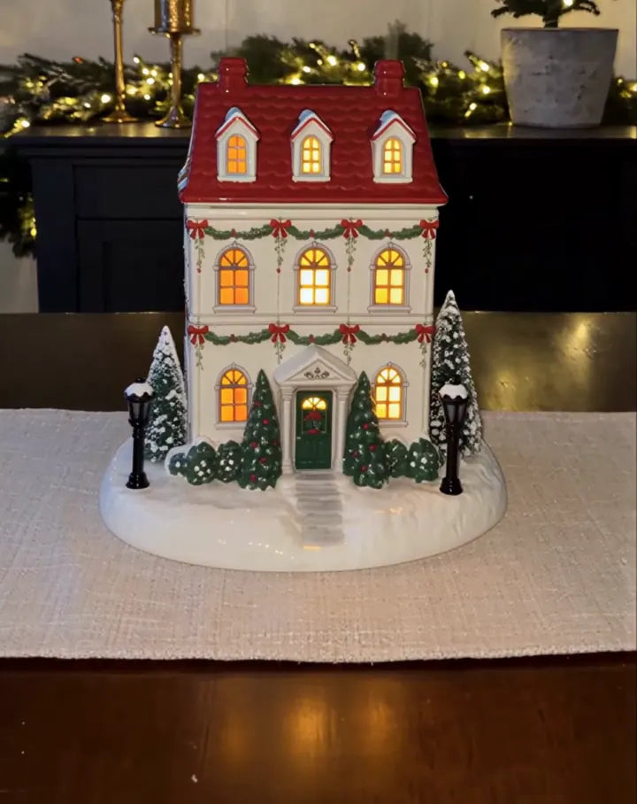 Illuminated Christmas cottage diffuser on a tabletop