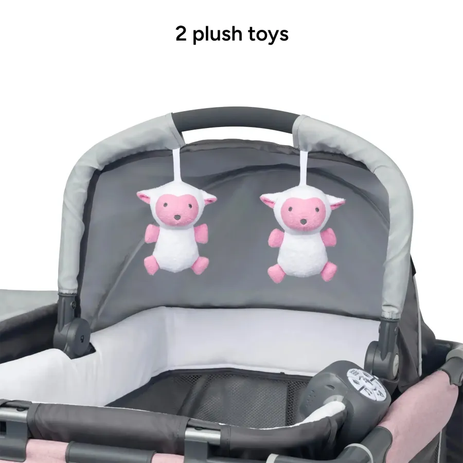 Two pink plush toys suspended from the bassinet canopy