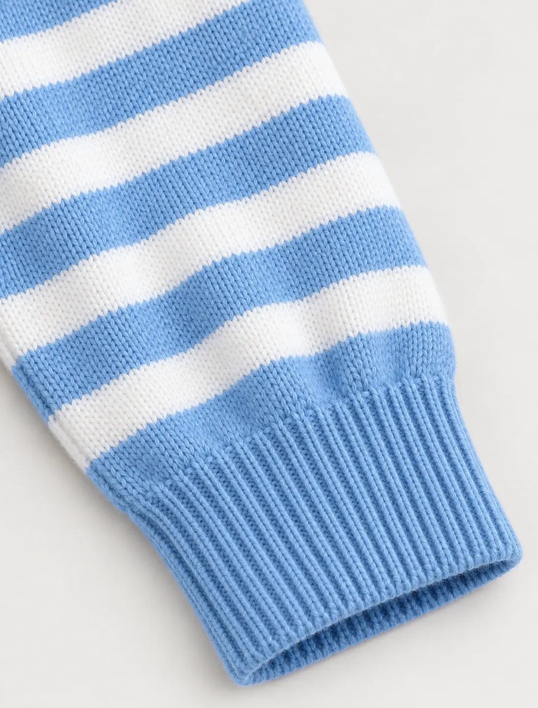 Striped sleeve and rib-knit cuff detail