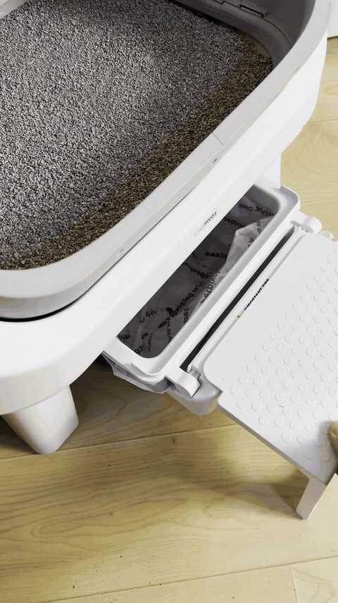 Waste drawer pulled out from the front of the litter box for a liner change